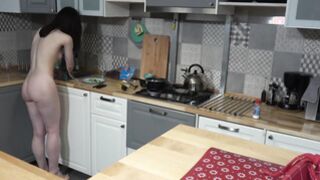 Pretty brunnette makes breaskfast in the kitchen completely nude